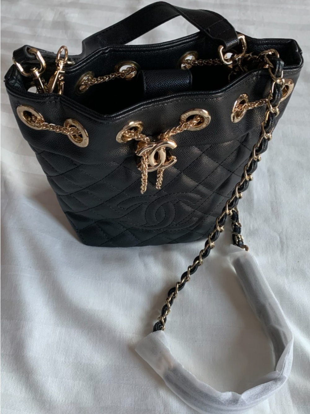 Novelty VIP Black Quilted Bucket Bag from Chanel with Gold Chain Details
